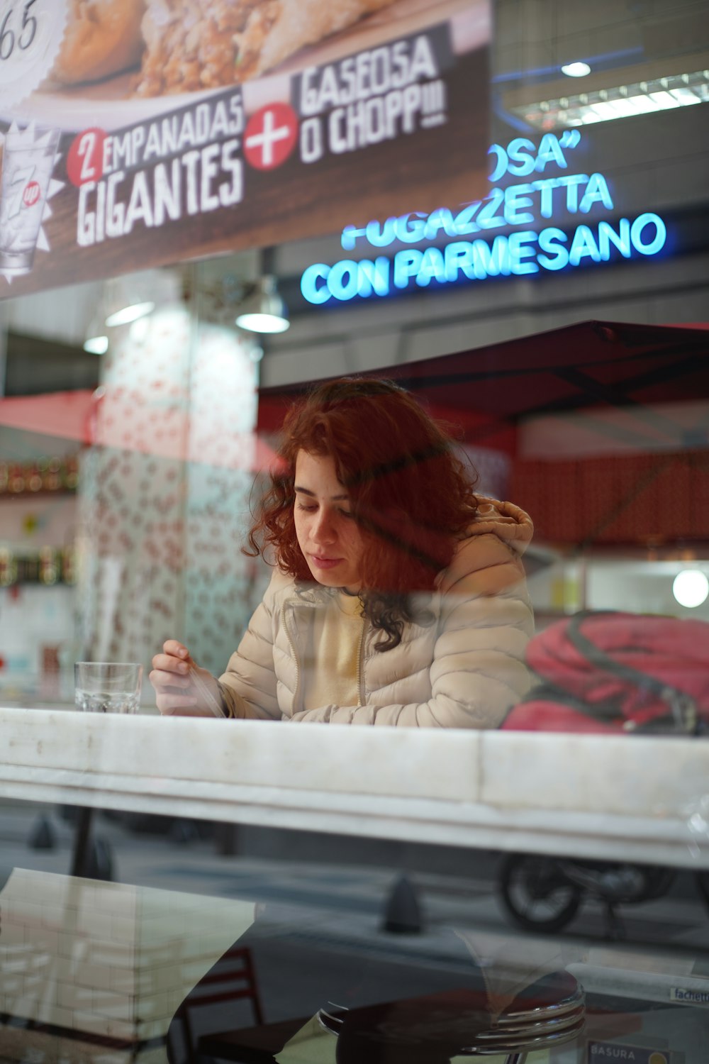 woman in bubble coat sitting in front of table