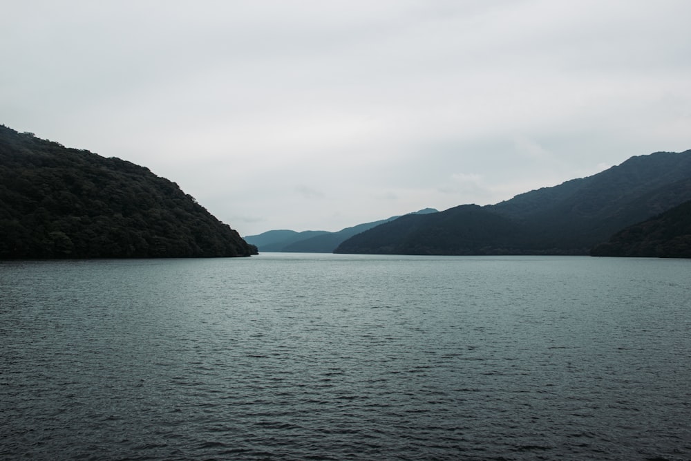 calm body of water and mountain