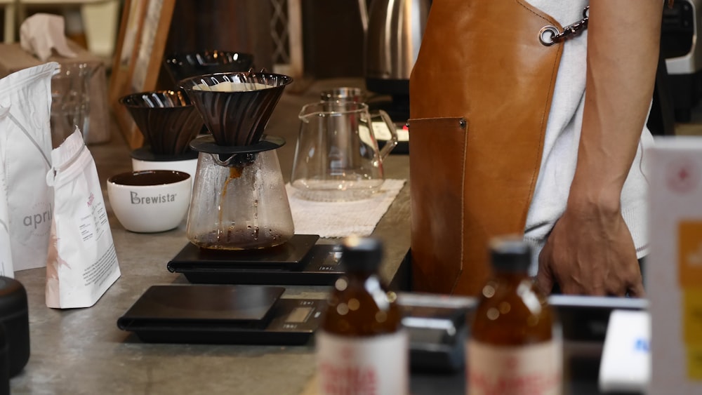 person wearing brown leather apron