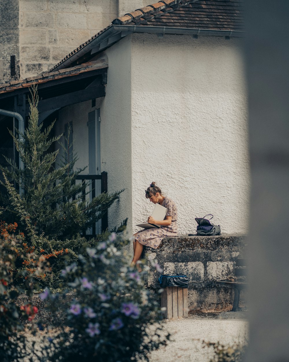 woman sitting on grey surface