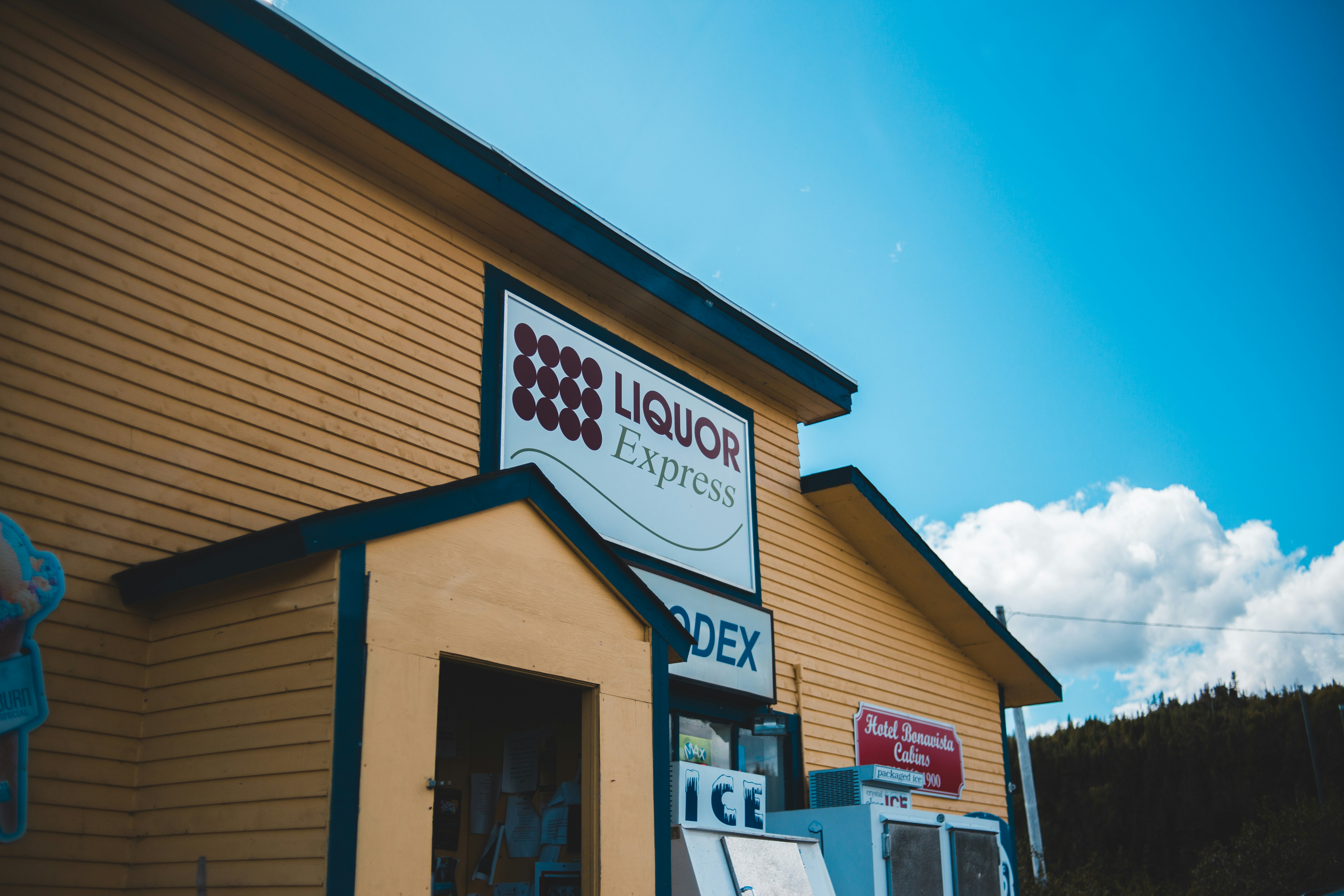 a yellow building with a sign that says liquor express