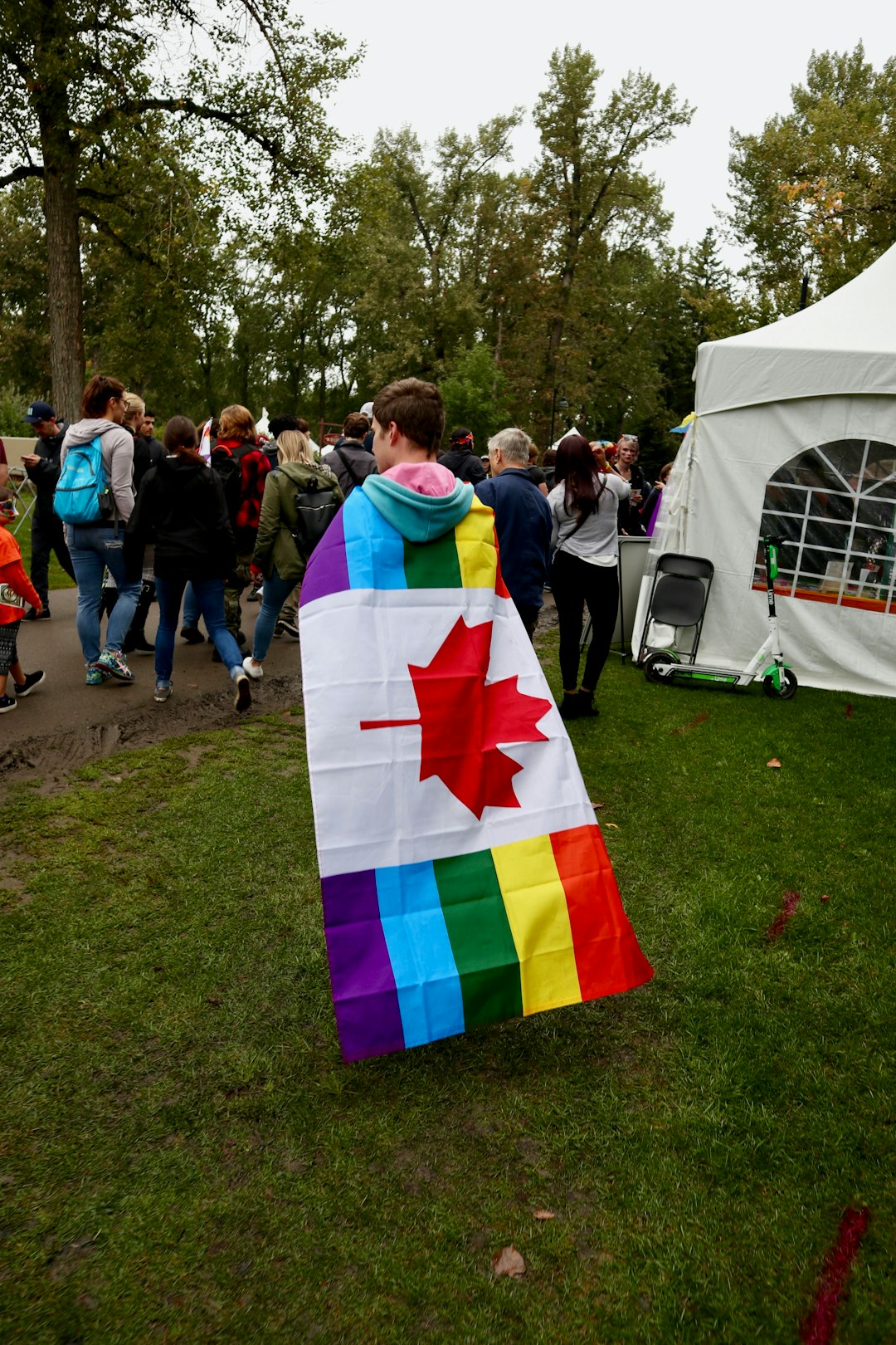 person carrying LGBT Canada flag