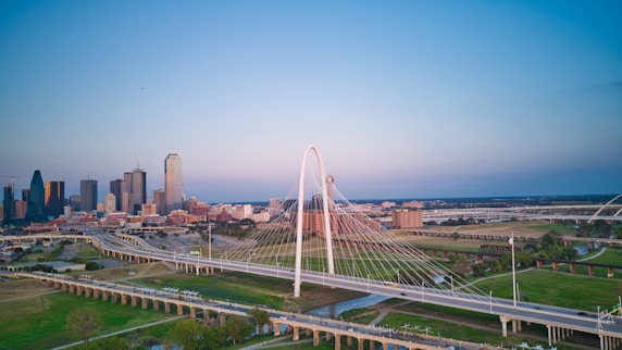 an aerial view of a city with a bridge in the foreground