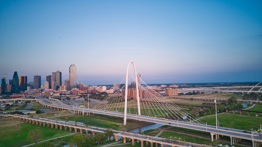 an aerial view of a city with a bridge in the foreground