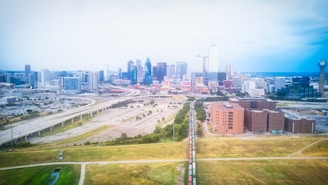 A scenic view of Durgapur city skyline with highway and railway tracks weaving through urban greenery.