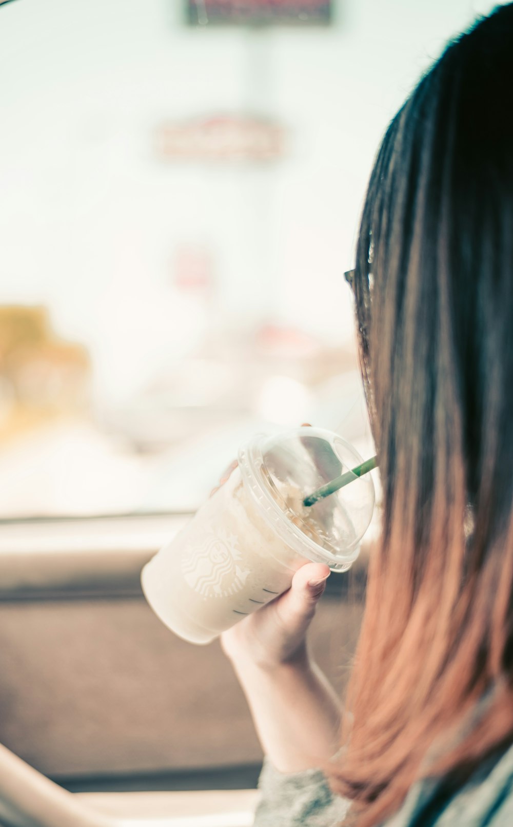 woman holding disposable cup