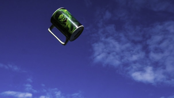 A vibrant mug with swirling rainbow colors and a playful design.