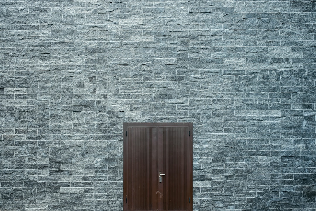 brown wooden door on gray wall