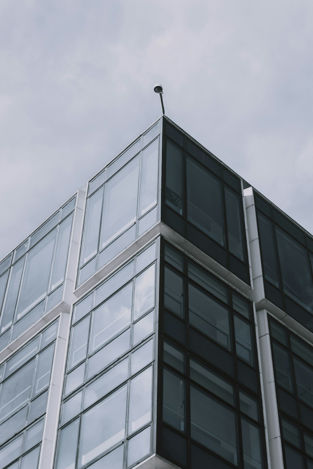 grayscale photography of curtain wall building