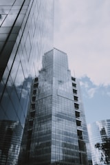 Commercial office buildings with glass facades reflecting the city skyline.