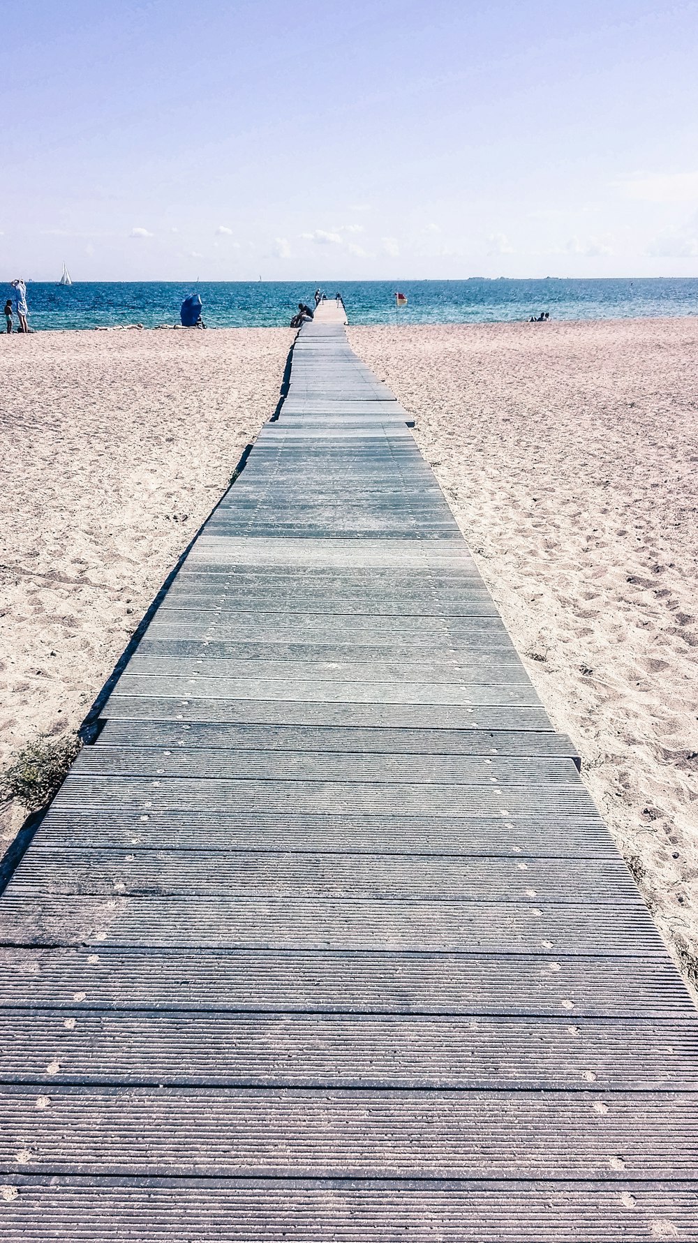 gray wooden beach dock viewing blue sea during daytime