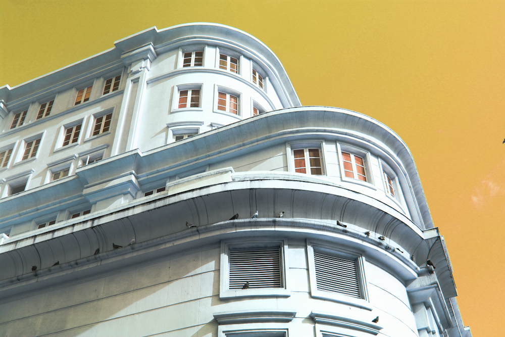 low-angle photography of white concrete multi-story building