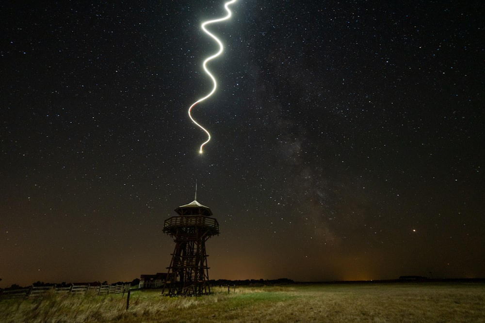 spiral light above tower during night