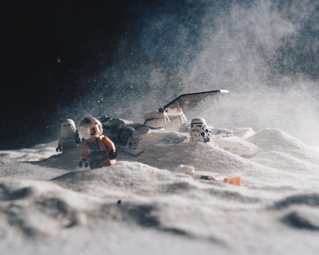 astronauts beside spaceship on sand miniature