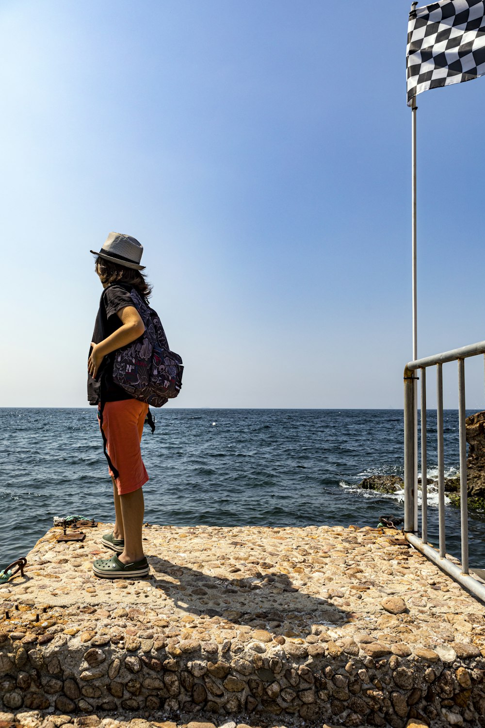 woman standing near seawall