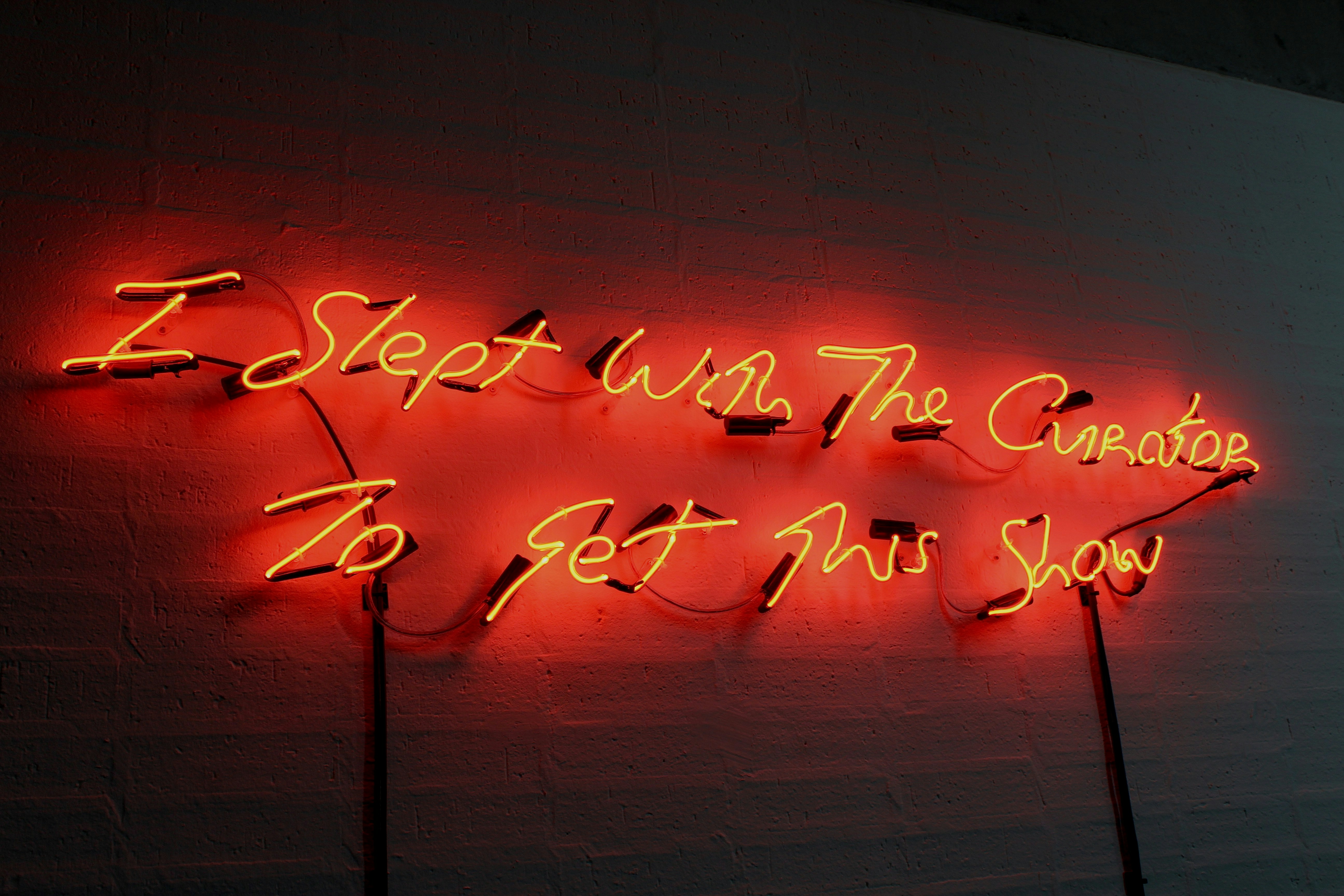 a neon sign that reads, i slept with the chaos to get my show (Photo by Archives of India on Unsplash)