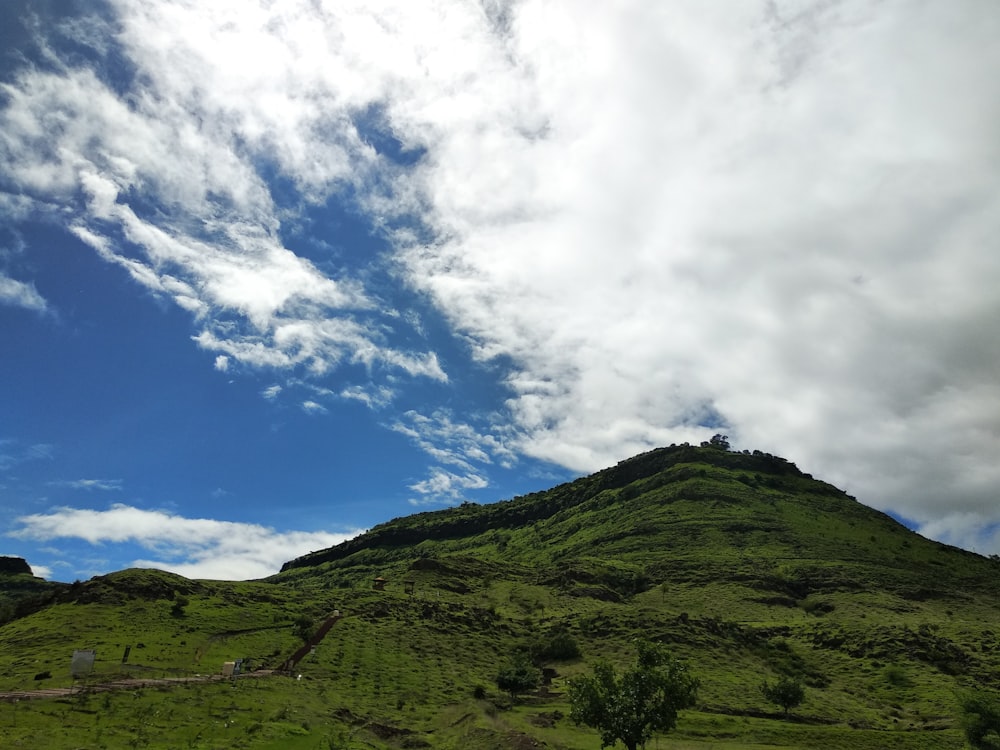 hill under cloudy sky