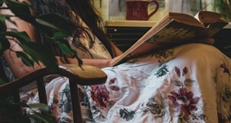 Close-up of a person reading a botanical skincare ebook on a tablet in a cozy setting.