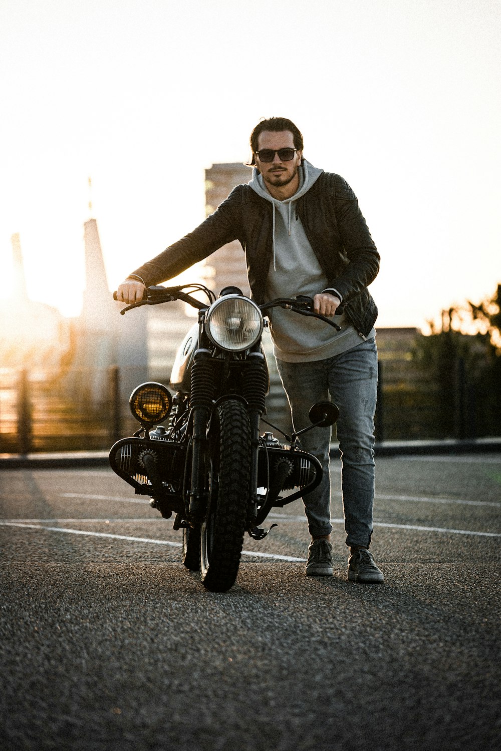 man holding motorcycle
