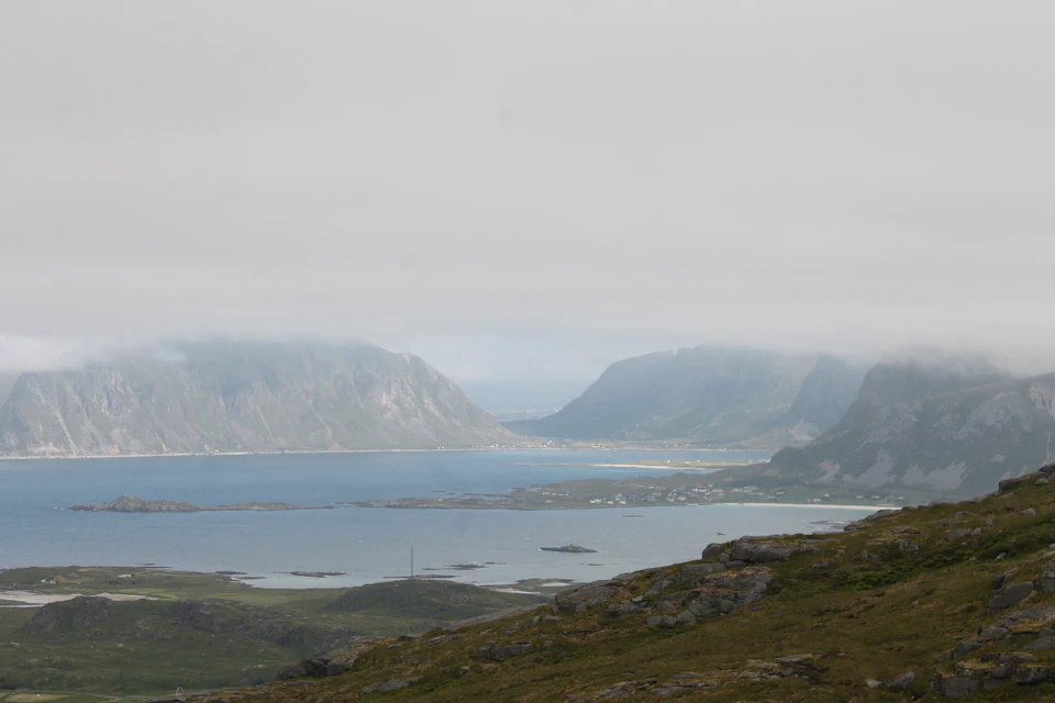 Serene ocean landscape with scattered islands under overcast sky and soft diffused light