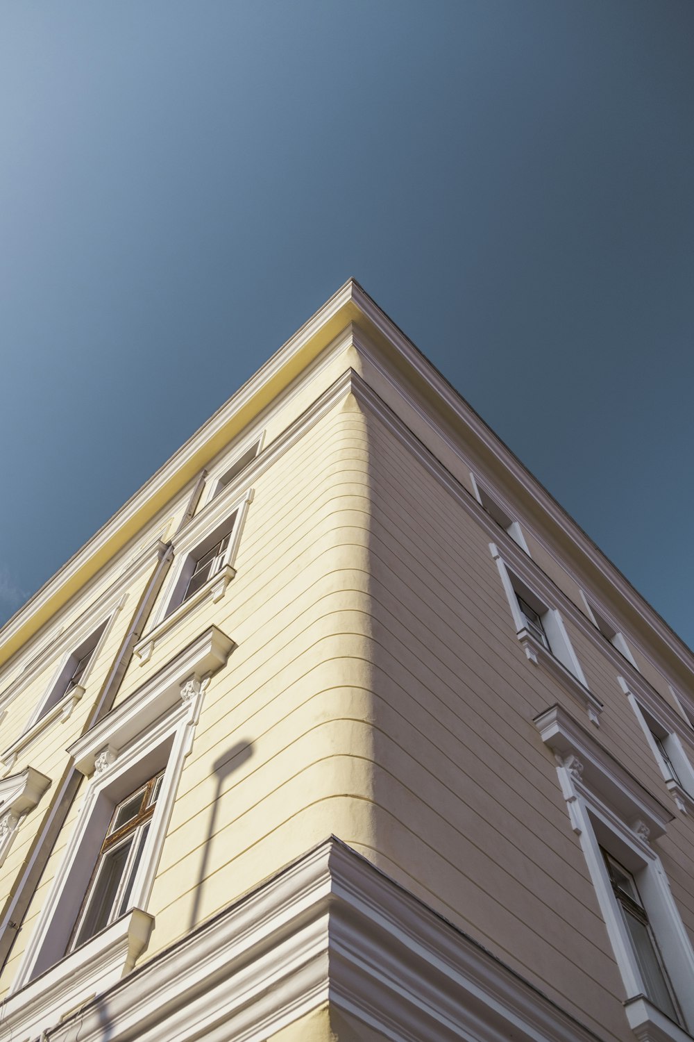 low-angle photography of pink concrete building during daytime