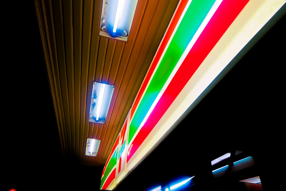 turned-on signage and fluorescent tubes on ceiling