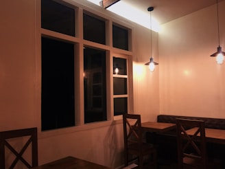 Interior of a cozy restaurant dining area with wooden tables.