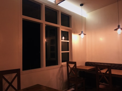 A cozy restaurant dining area with wooden tables and warm lighting.