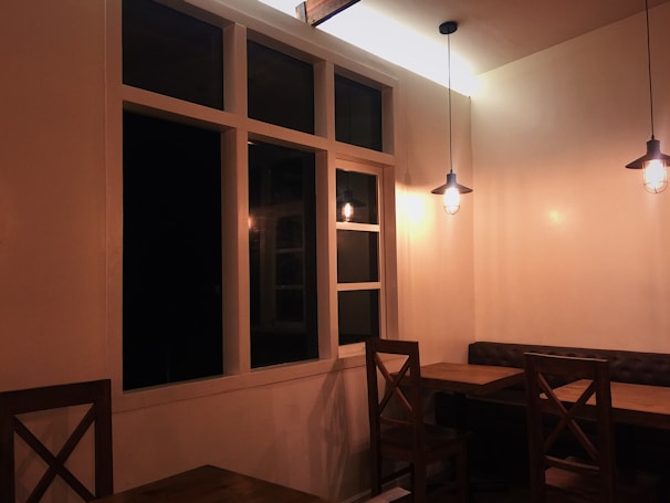 Interior of a cozy restaurant dining area with wooden tables.