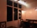 A warm dining area with wooden tables and soft lighting, inviting guests to enjoy a meal.