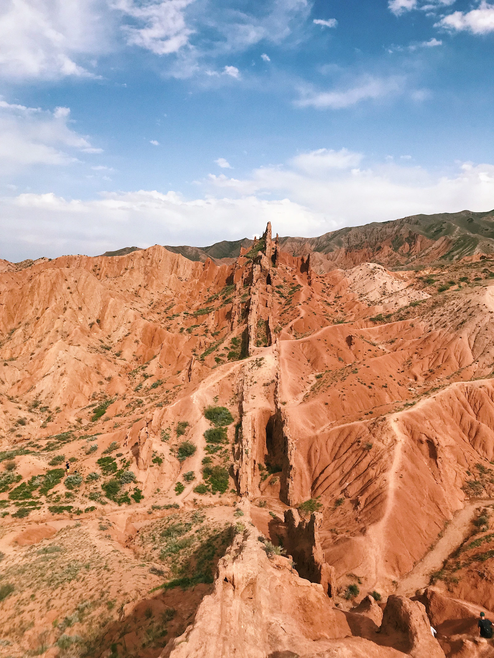 Warm brown canyon formations beneath a blue sky in Tong, Kyrgyzstan