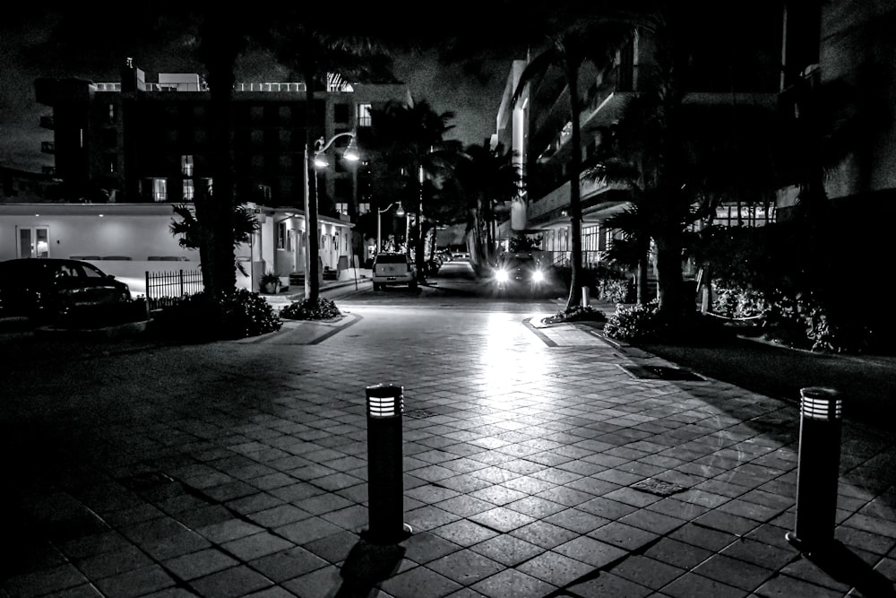 a black and white photo of a street at night