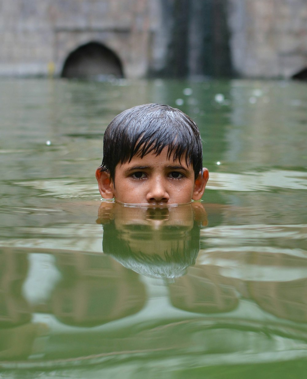 boy swims in body of water