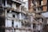A heavily damaged and partially collapsed building with exposed interiors and debris scattered throughout. The structure appears old, with visible steel bars, electrical wiring, and shattered walls. The scene suggests a recent demolition or natural disaster aftermath.