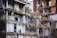 A heavily damaged and partially collapsed building with exposed interiors and debris scattered throughout. The structure appears old, with visible steel bars, electrical wiring, and shattered walls. The scene suggests a recent demolition or natural disaster aftermath.