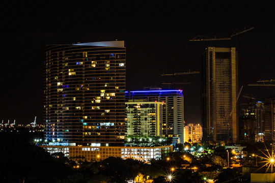 A sleek nighttime city skyline highlighting illuminated skyscrapers with integrated HVAC systems.