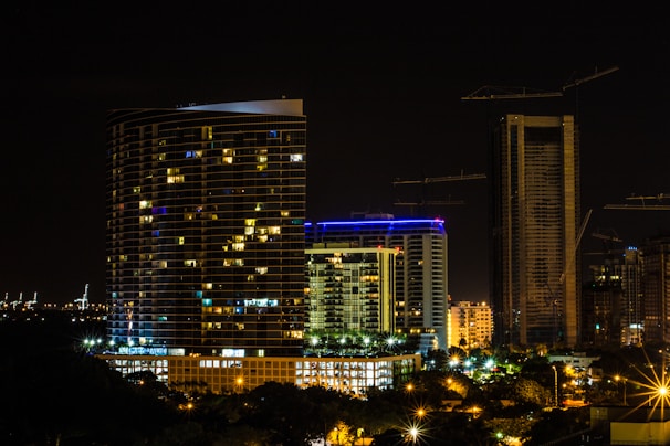 A nighttime cityscape with illuminated skyscrapers symbolizing innovation and sustainable growth.
