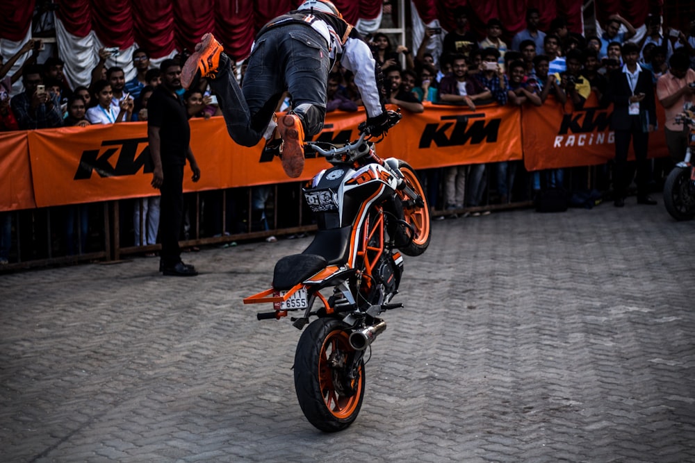 man performing trick while riding motorcycle