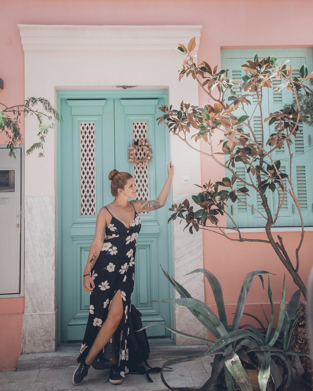 woman wearing black and white floral spaghetti-strap dress