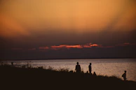 Sunset view over Langley Township with silhouettes of people walking home after a community event.