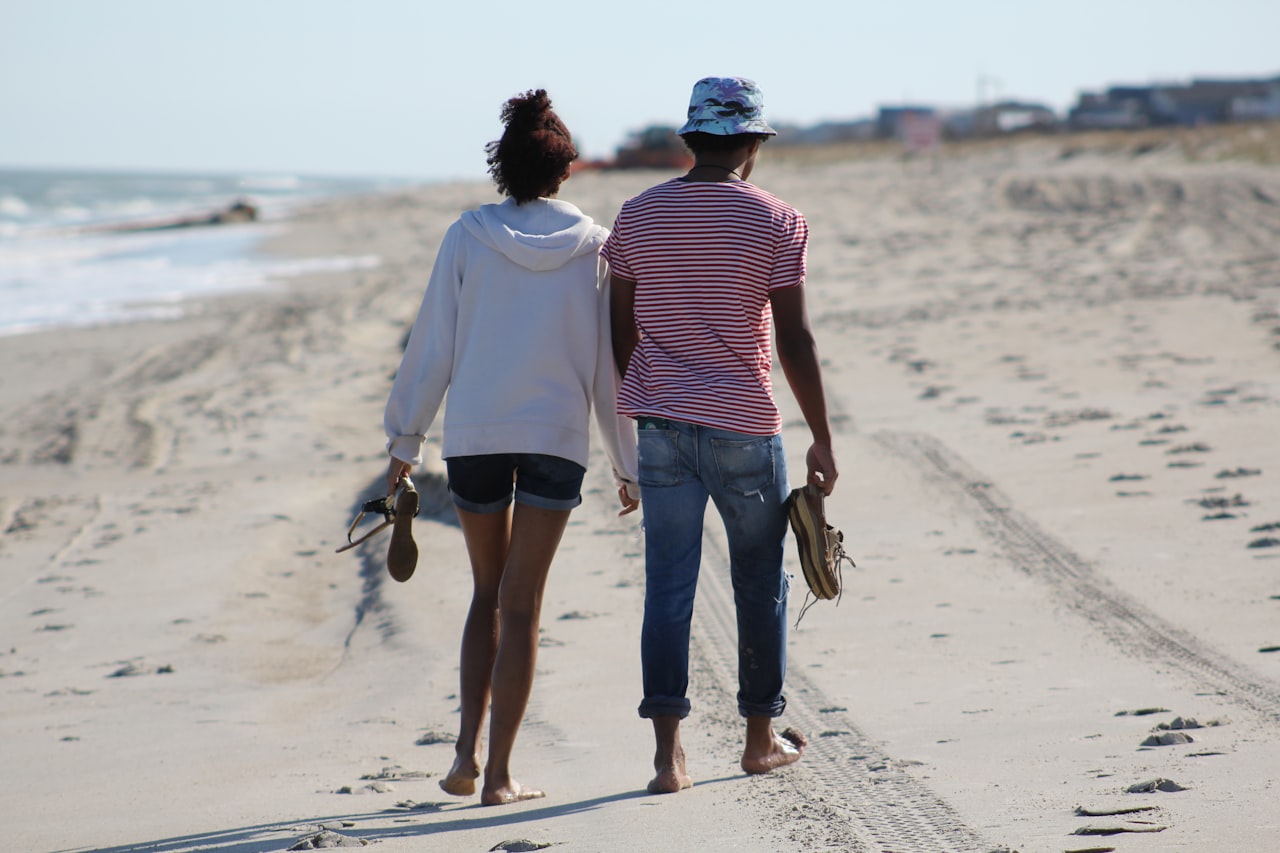 Couple walking along the beach in panama City Beach Florida enjoying the relaxed retirement lifestyle