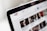 A close-up view of a computer screen displaying a YouTube page, showing the logo and multiple video thumbnails in a recommended section.