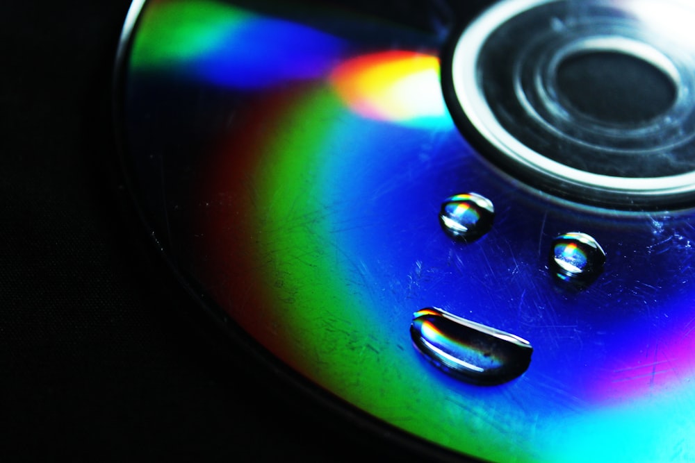 a close up of a cd disc with a rainbow tint