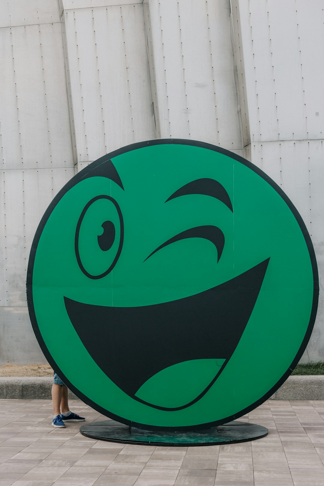 Green animated face winking