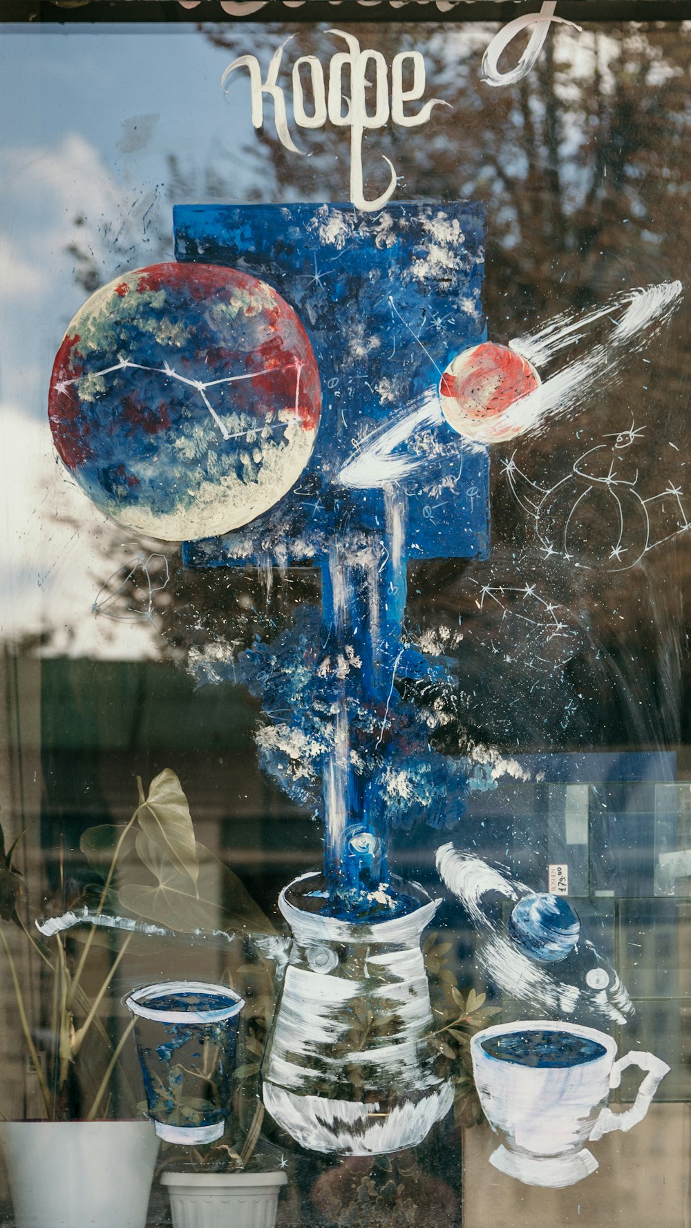 a window display of coffee cups and vases