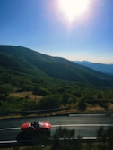 A vibrant image of a car driving on a scenic road.