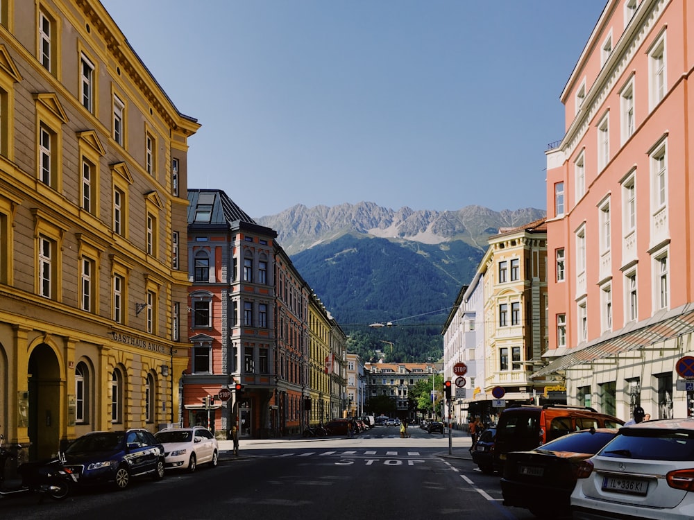 vehicles parked on side of road between buildings