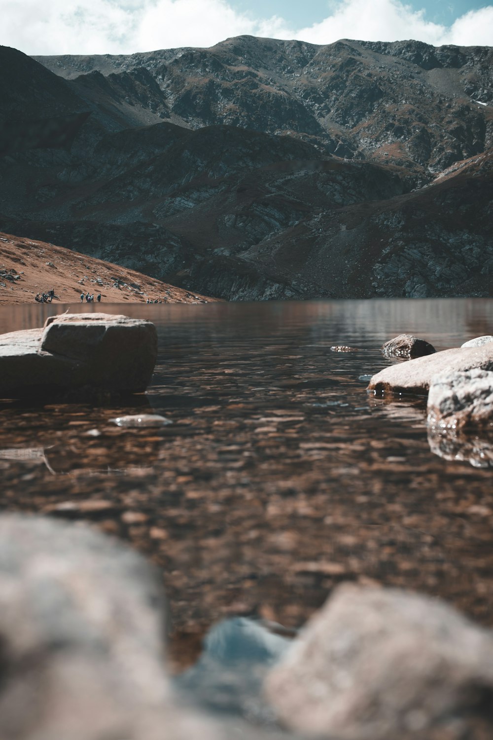 a body of water surrounded by mountains and rocks