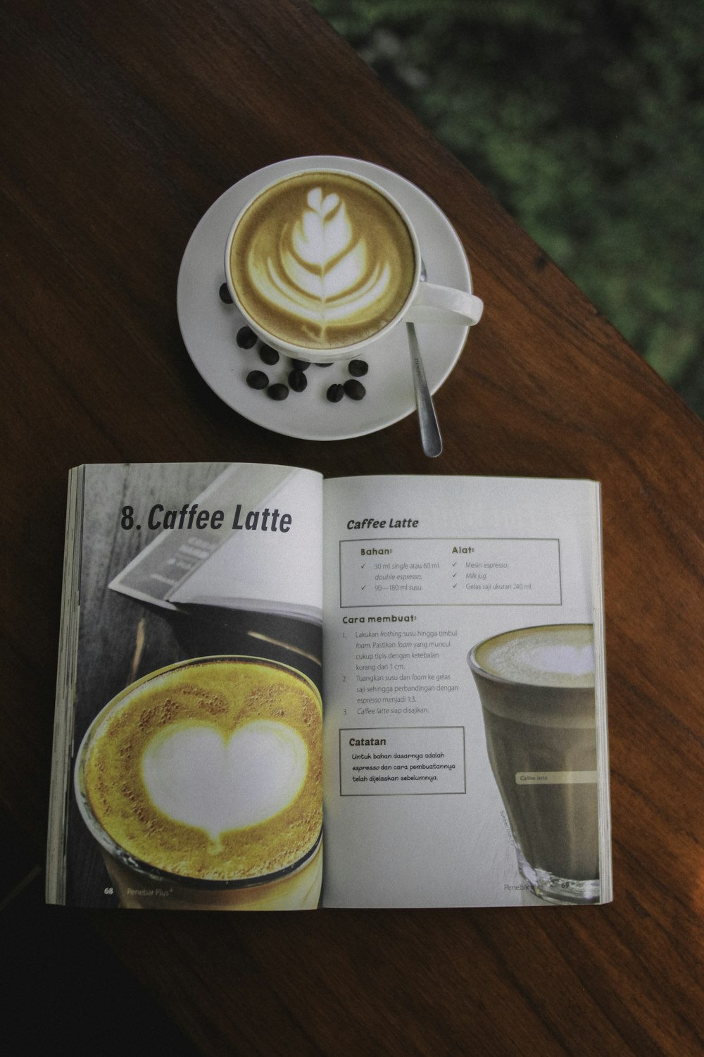 white ceramic mug beside book