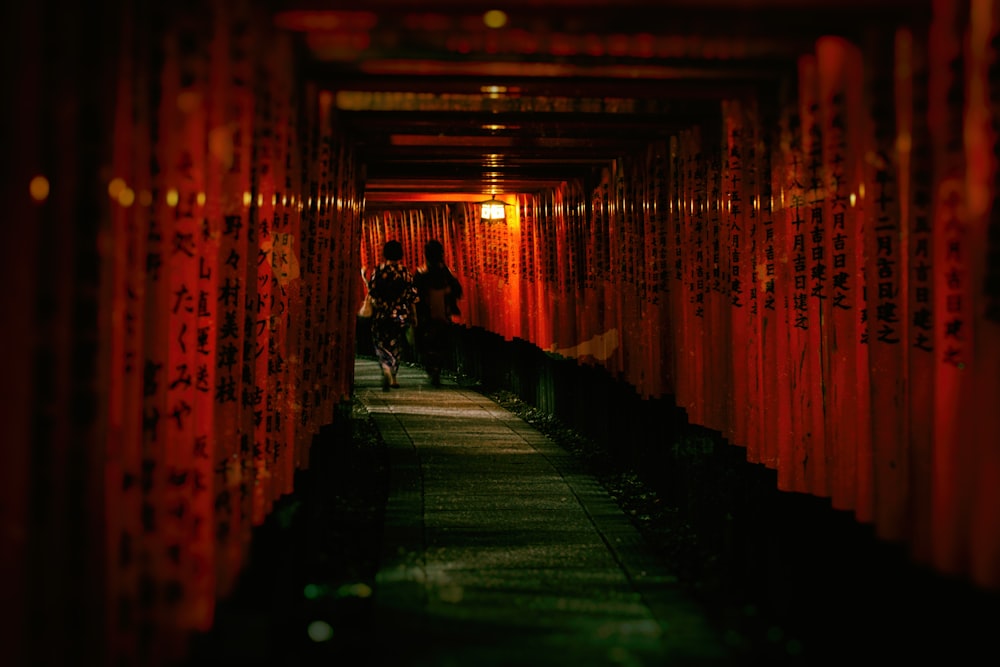 a person riding a bike through a tunnel